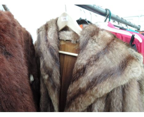A three quarter length fur coat with shawl collar