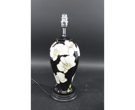 MODERN MOORCROFT LAMP in the Moth Orchid design, with a metal light fitting and wooden stand. With a shade and shade attachme