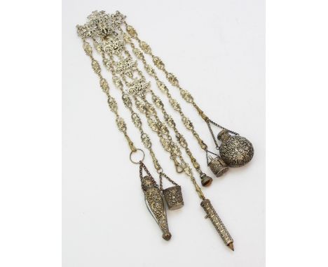 A vintage silver plated chatelaine with fancy links, attachments to inc a propelling pencil, fob seal, two scent bottles, a t