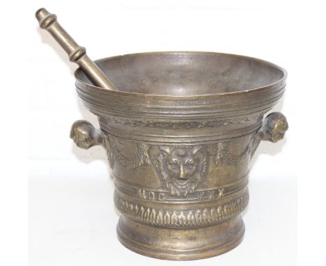 A very large vintage pestle and mortar with decorative masks, made from a bronze-like copper alloy, 25cm in diameter x 21cm t