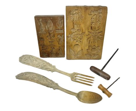 Two wooden biscuit moulds, carved loving spoon and fork, and two bradawls 