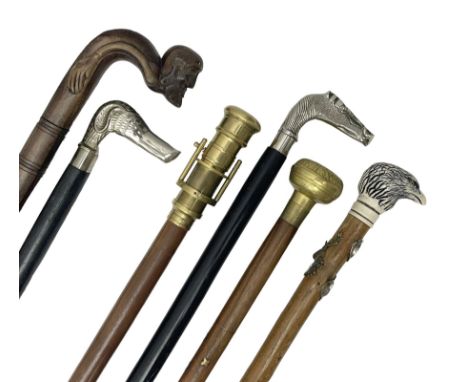 Six walking sticks including a walking stick with telescope to the top, carved resin cap modelled as an eagle with Yorkshire 