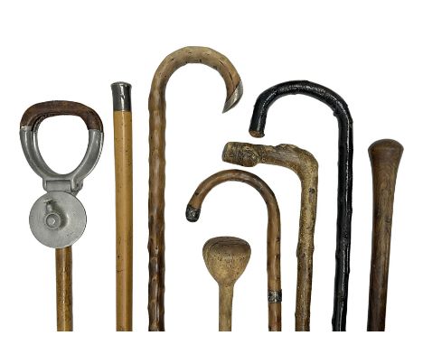 Six walking sticks, to include two hallmarked silver capped examples, together with a  shooting stick