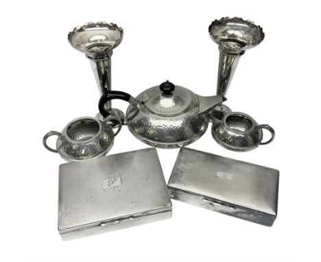 Three piece Arts and Crafts style hammered pewter tea service, comprising teapot, open sucrier and milk jug, together with a 