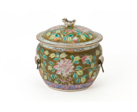 AN OLIVE GROUND FAMILLE ROSE KAMCHENG
The cover with foo dog finial and the body with four lugs, decorated with peonies, lotu