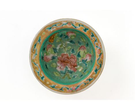 A TURQUOISE GROUND FAMILLE ROSE COSMETIC OIL BOWL
The interior decorated with lotus and peonies amongst vines, with a pale pi