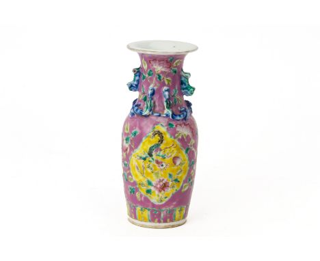 A PINK GROUND FAMILLE ROSE PORCELAIN VASE
With foo dog handles and scrolling dragons to the neck, the main body decorated wit