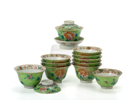 A GROUP OF LIME GREEN GROUND PORCELAIN TEA BOWLS The tea bowls decorated with butterflies, vines and peonies to the exterior,