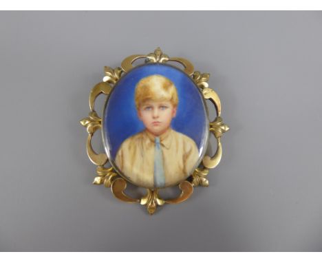 An Antique Yellow Metal Mourning Pendant Portrait, depicting a young boy, approx 31.3 gms.