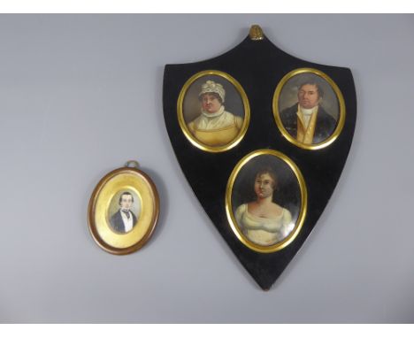 A Georgian Portrait Miniature Trio, in shield form frame, together with an antique portrait miniature depicting a gentleman. 