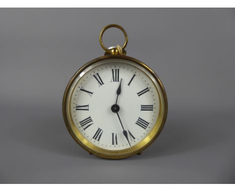 A French R & Co Brass Clock, enamel face with Roman dial, approx 14 cms.