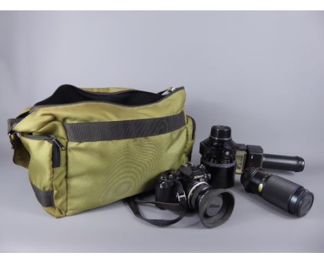 A Nikon Camera Body together with a Nikon 50mm Vivitar Auto Zoom, telephoto lens and flash-gun in canvas camera bag.