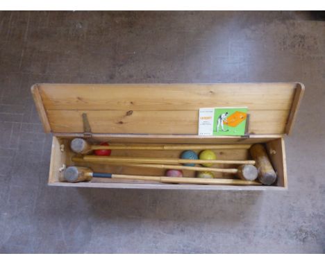 A Vintage 'Croquet Association' Set, two mallets and a set of balls, contained within a pine box and instruction manual.