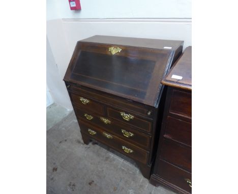 An Antique Drop Front Writing Bureau, the bureau having fitted pigeon hole interior, two short and three long drawers, raised