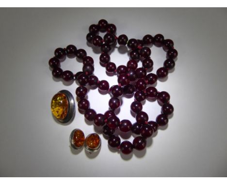 A Set of Dark Red Amber Beads, approx 11 mm, approx 82 cms, approx 70 gms together with a pair of sterling silver light amber