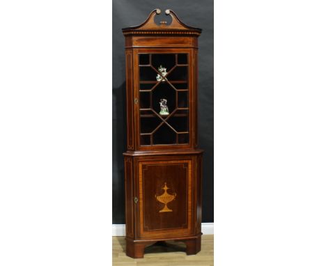 An Edwardian Sheraton Revival mahogany and marquetry splay-fronted corner display cabinet, swan neck pediment above an astrag