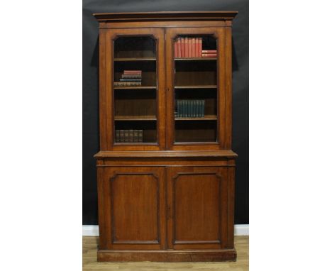 A 19th century oak library bookcase, moulded cornice above a pair of glazed doors enclosing three adjustable shelves, the pro