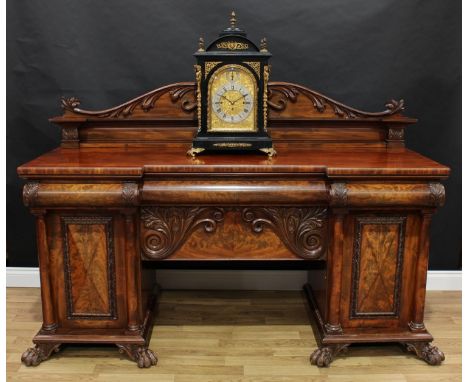 A Scottish Regency mahogany inverted break-centre sideboard, shaped gallery carved and applied with stiff and scrolling acant