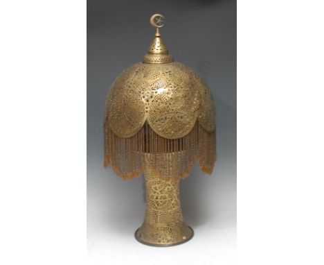 A Moorish Revival brass table lamp, pierced base and shade with beaded fringe, 61cm high 