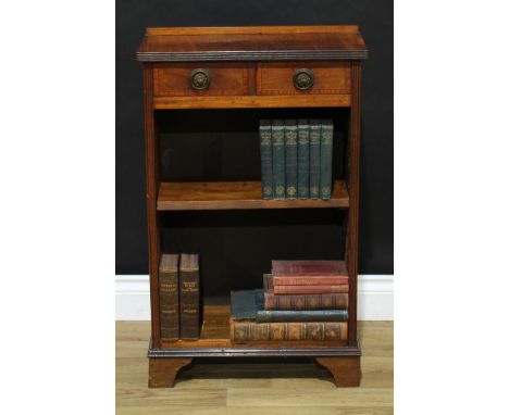 A Sheraton Revival mahogany open bookcase, of small proportions, oversailing reeded top above a pair of crossbanded drawers, 