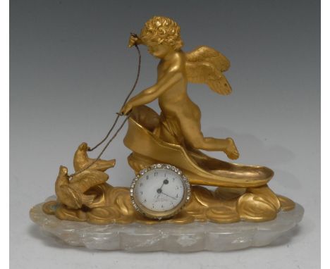 A Louis XV design gilt bonze and rock crystal manel time piece, the sculptural case cast as an amorini in a chariot drawn by 