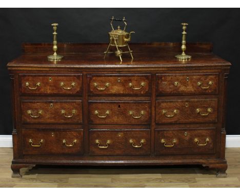 A George III mahogany crossbanded oak housekeeper's chest or low dresser, rectangular top with shallow half gallery above an 