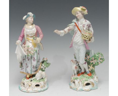 A pair of Derby Patch Mark figures, Shepherd adn Shepherdess, he stands wearing a plummed hat, holding a basket of flowers, a