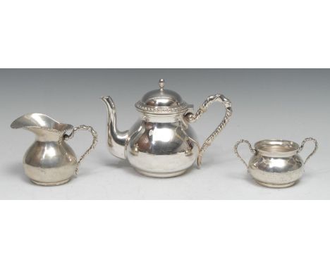 An Italian silver three piece tea service, comprising teapot, milk jug and sugar basin, rope-twist borders and handles, the t