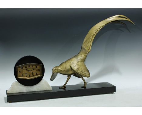 An Art Deco marble and spelter clock, circular black marble clock face with angular brass dial, Arabic numerals, twin winding