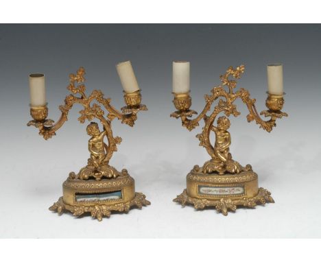 A pair of 19th century French gilt metal and porcelain mounted two-light mantel candelabra, in the Louis XV taste, each cast 