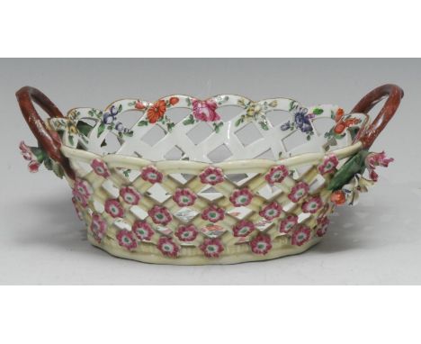 A Worcester oval basket, the interior  well-painted with large colourful bouquet of flowers, the exterior applied with pink f