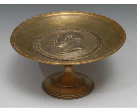 A 19th centurty gilt metal tazza, the dished circular top centred by a portrait roundel, within a bay leaf bezel, beaded bord