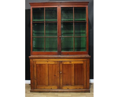 A substantial country house pine gun display cabinet, moulded cornice above a pair of glazed doors enclosing nine provisions 