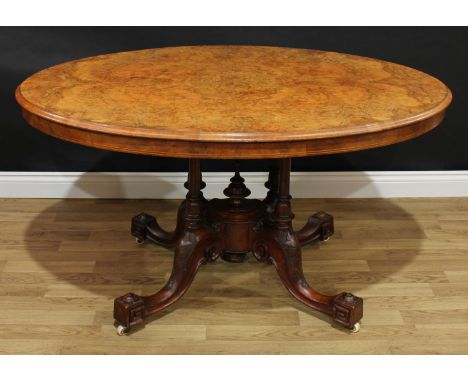 A Victorian walnut and marquetry oval centre table, quarter-veneered tilting top inlaid in boxwood with stylised foliage, qua