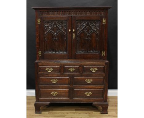 Frank Pratt of Derby - a 17th century style oak press cupboard, moulded cornice above a nulled frieze and a pair of panel doo