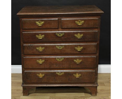 A 19th century oak chest, slightly oversailing rectangular top above two short and four long graduated drawers, brass swing h