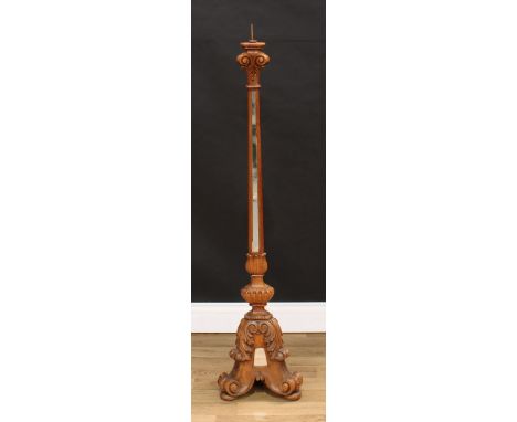 A North European walnut floor-standing pricket candlestick, iron spike, triform pillar set with mirrored panels, the capital 