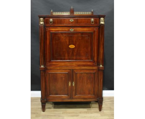 A French Empire mahogany Secrétaire à abattant, pierced brass pediment above a long drawer and a fall front door inlaid with 