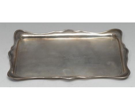 A George V silver shaped rectangular dressing table tray, engine turned field, 30cm wide, Birmingham 1922, 12.75oz 