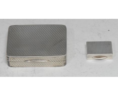 A George V silver vanity box, engine turned overall, hinged cover, the gilt interior with mirror, 6cm wide, London 1919; an E