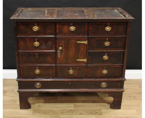 A '18th century' laburnum cabinet on stand, shallow cornice above an arrangement of ten small drawers and a cupboard, the bas