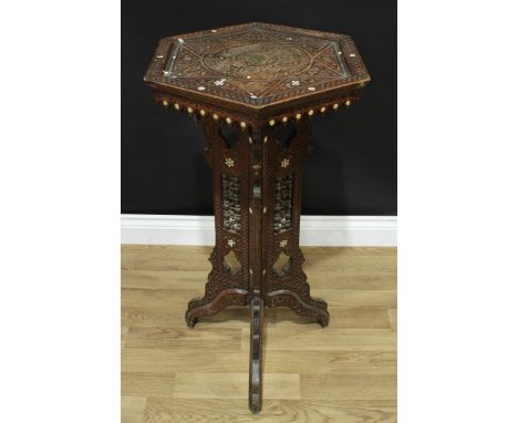 A late 19th century 'Moorish' hardwood occasional table, dished hexagonal top carved in relief with Islamic script, the trifo