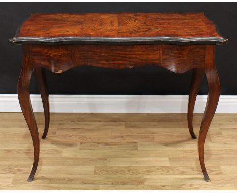 A 19th century walnut and ebonised serpentine card table, in the French taste, hinged top enclosing an inset tooled velvet li