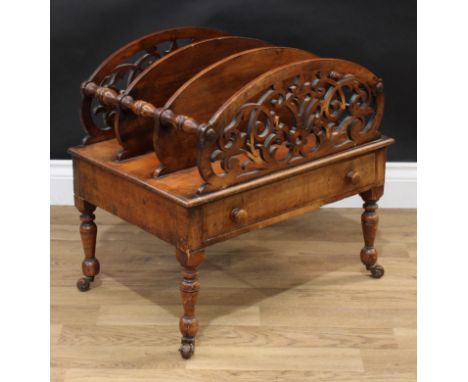 A late Victorian mahogany three section Canterbury, each shaped end division pierced with scrolling foliage, drawer to frieze