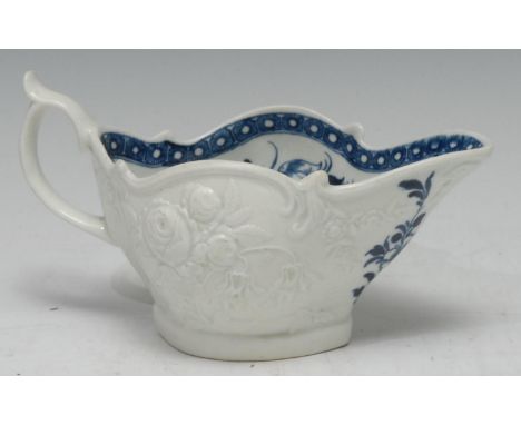A Worcester Peony pattern sauce boat, the exterior in relief with rose and fuchsias, the interior in under glaze blue with pe