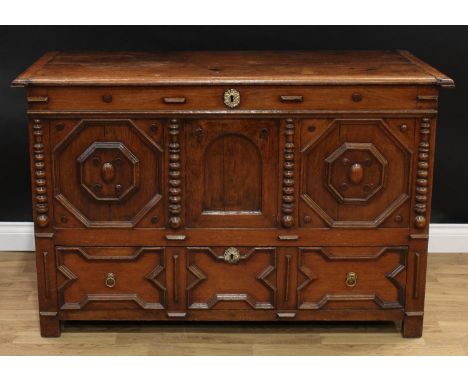 A 'Charles II' oak mule chest, hinged rectangular top enclosing a till, the three panel front applied with geometric moulding