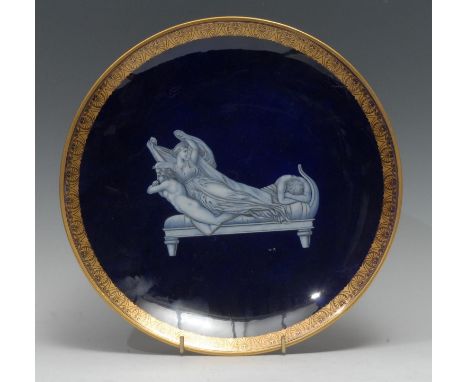 A Royal Worcester pate-sur-pate circular plate, decorated after the Ancient Greek on a cobalt blue ground, tooled gilt palmet