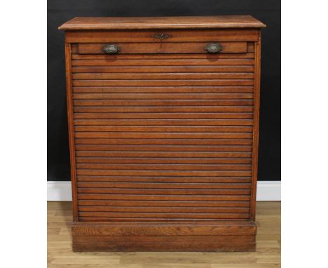 An early 20th century oak tambour-front filing cabinet, in the manner of Globe Wernicke, retractable cover enclosing two rows