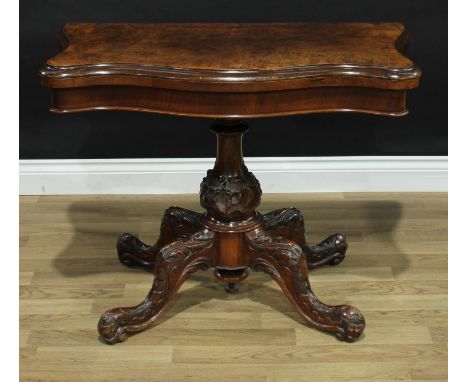 A Victorian walnut serpentine card table, folding top enclosing an inset baize lined playing surface, above a deep frieze, tu