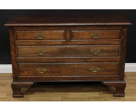 Frank Pratt of Derby - an oak chest, moulded rectangular top above two short and two long drawers, brass swing handles, brack